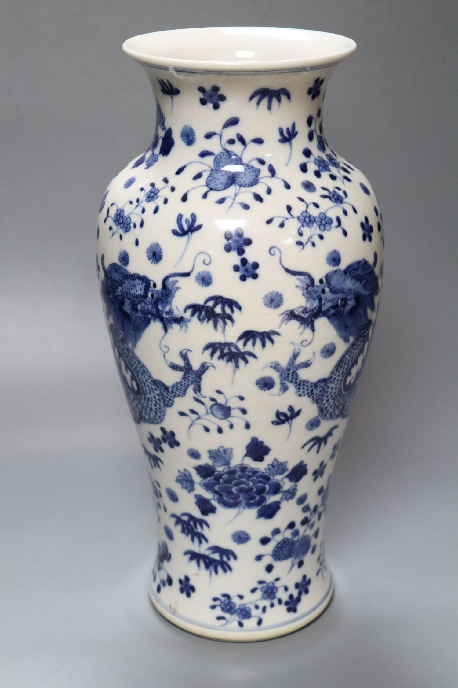 A Chinese porcelain baluster vase, painted with dragons and foliage, height 37cm